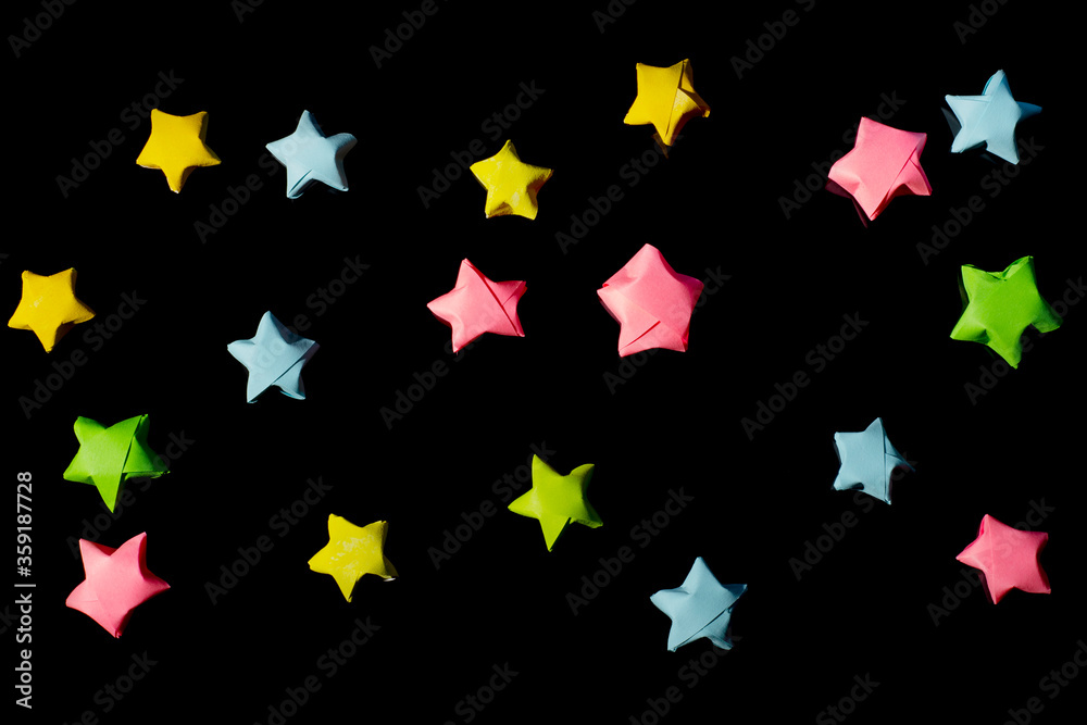 Black background with multi-colored paper stars. Children's pattern for printing on fabrics, covers or wrappers. Black background with multi-colored paper stars. Children's pattern for printing on fabrics, covers or wrappers.
