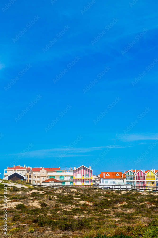 Costa Nova, Portugal: colorful striped beach houses called Palheiros next to Atlantic coast near Aveiro.