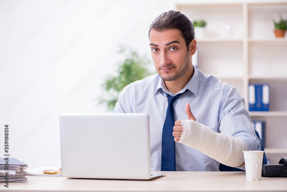 Injured male employee at workplace after accident Injured male employee at workplace after accident