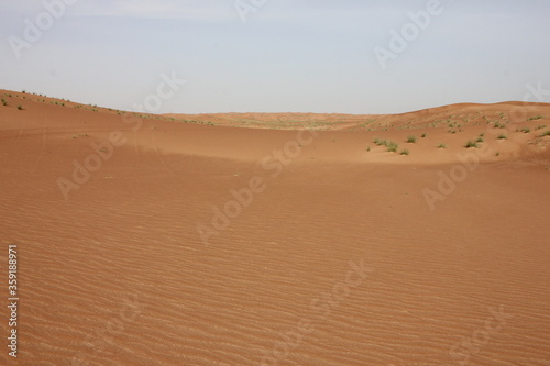 Hot and arid desert sand dunes terrain in Sharjah emirate in the United Arab Emirates. The oil-rich UAE receives less than 4 inches of rainfall a year and relies on water from desalination plants.