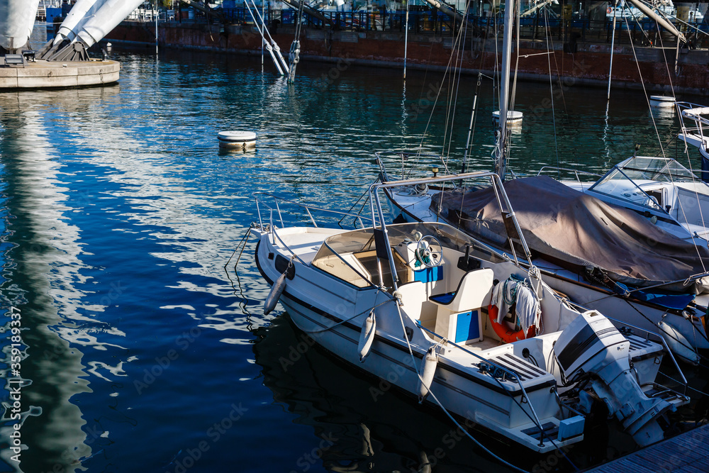 Yacht in port near the pier. Speed boat mooring. Boat Parking Boating Yachting Equipment.