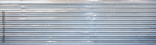 iron wall. Corrugated iron. Galvanized iron wall plate background. sheet wall panel. Sheet Metal with little light