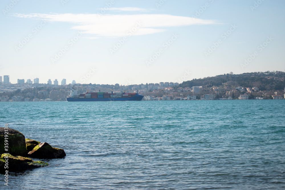 large cargo ship passing through the Bosphorus of Istanbul