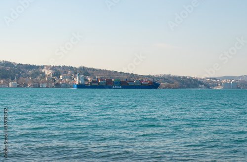 large cargo ship passing through the Bosphorus of Istanbul