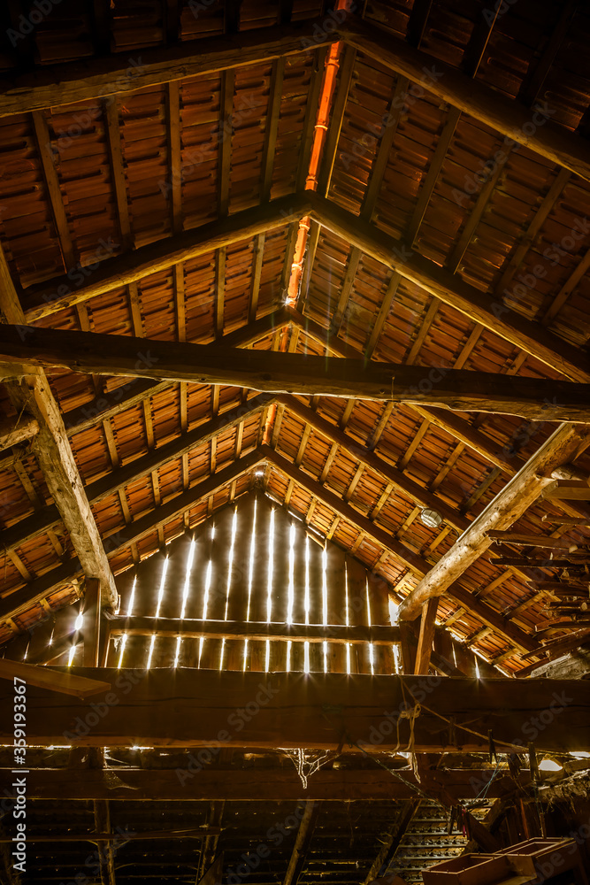 Interior of old wooden shed with scrap wood with sunrays