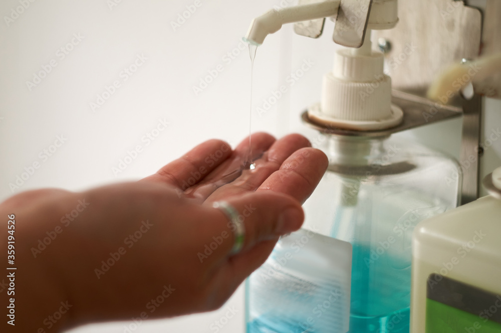 Close up of a medical worker in protective clothing washing her hands. Close up of a medical worker in protective clothing washing her hands.