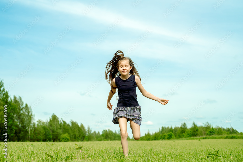 Girl, jumping in the field.running and jumping. happy childhood, hot summers, freedom and lifestyle. wind in hair Girl, jumping in the field.running and jumping. happy childhood, hot summers, freedom and lifestyle. wind in hair