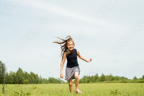 Girl, jumping in the field.running and jumping. happy childhood, hot summers, freedom and lifestyle. wind in hair © irishasel