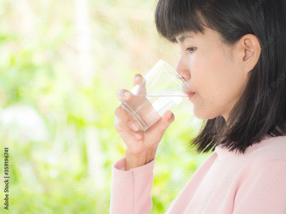 Close up asian woman drinking water on blur background. Close up asian woman drinking water on blur background.