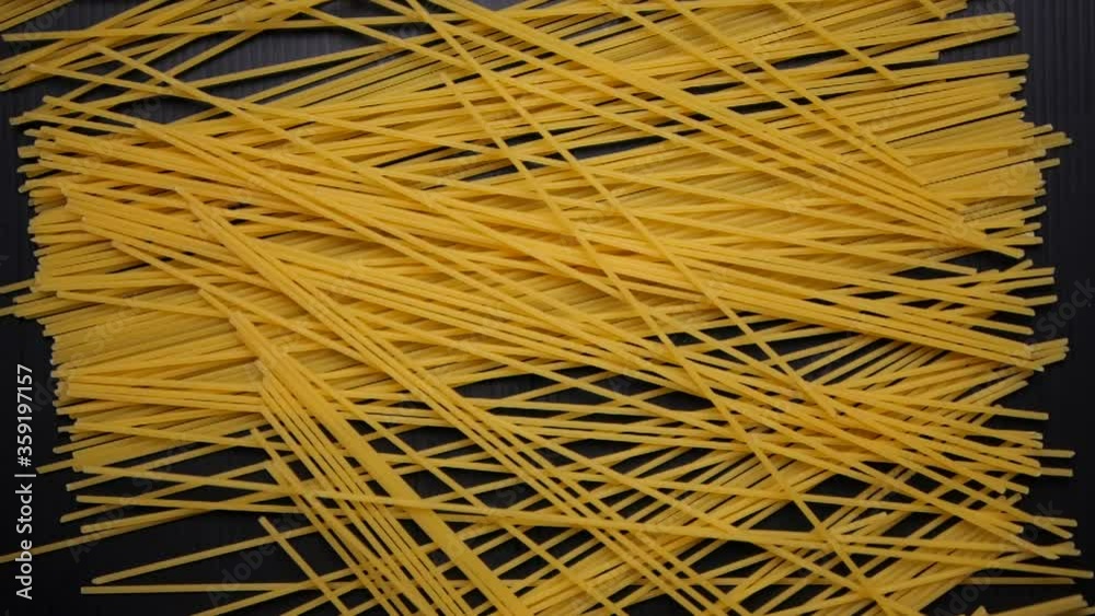 Spaghetti falling on black in slow motion, Top view Spaghetti falling on black in slow motion, Top view