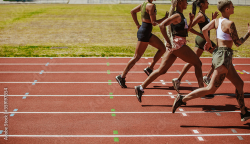 Female athletes running race on the track