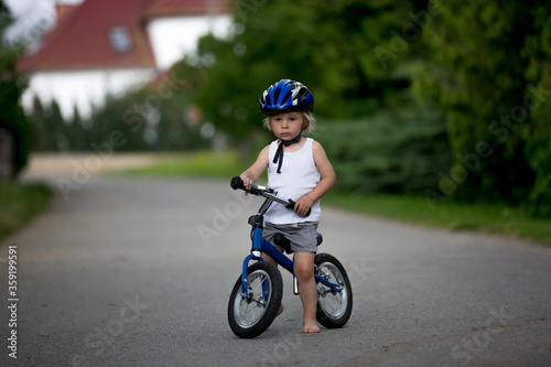 Child riding balance bike © Tomsickova
