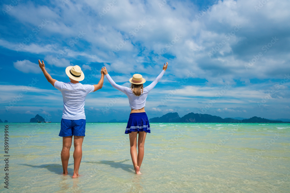 Young happy couple on tropical beach at summer vacation. Thailand Young happy couple on tropical beach at summer vacation. Thailand