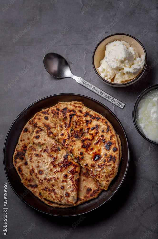 Aaloo parantha or stuffed potato flatbread with curd, pickle and homemade white butter Aaloo parantha or stuffed potato flatbread with curd, pickle and homemade white butter