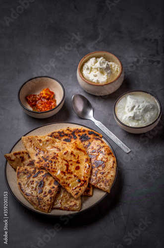 Aaloo parantha or stuffed potato flatbread with curd, pickle and homemade white butter