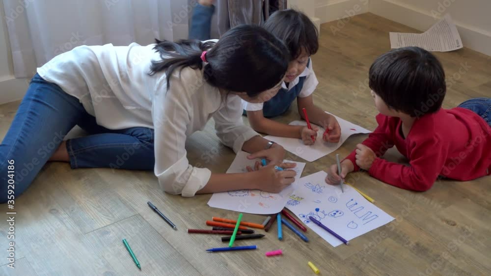 Family happy children group kids boy and girl kindergarten paint drawing on paper with teacher education together at interior nursery playroom, Back to school concept Family happy children group kids boy and girl kindergarten paint drawing on paper with teacher education together at interior nursery playroom, Back to school concept