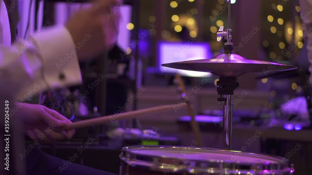 A drummer plays in a bar under light music. High quality FullHD footage A drummer plays in a bar under light music. High quality FullHD footage