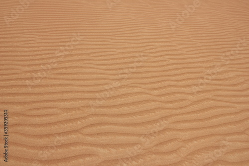 Hot and arid desert sand dunes terrain in Sharjah emirate in the United Arab Emirates. The oil-rich UAE receives less than 4 inches of rainfall a year and relies on water from desalination plants.