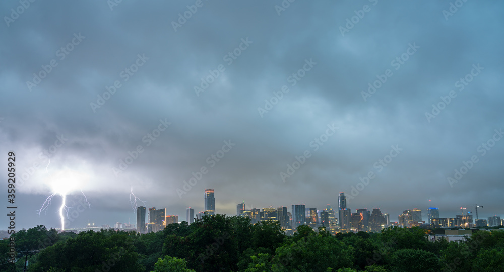 Large Lighning Striking on the Side of Austin Skyline During Large Morning Storm