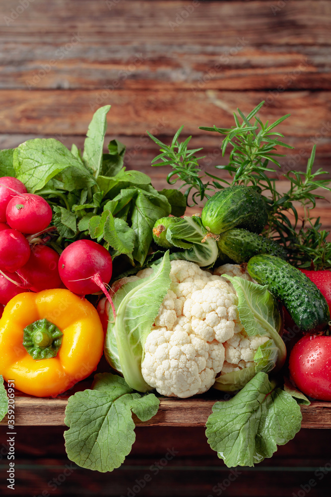 Various fresh raw vegetables on a wooden background. Various fresh raw vegetables on a wooden background.