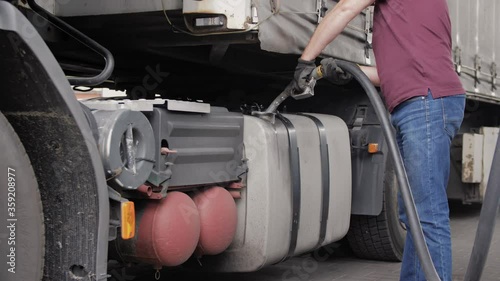 Filling car with gas fuel at station pump. 
Car transporter truck filling up with fuel. Diesel Oil.