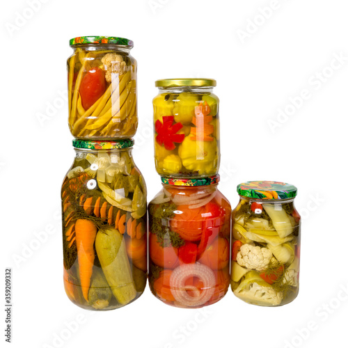 Canned vegetables in glass jars isolated on white background