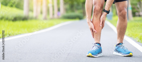 Young adult male with his muscle pain during running. runner man having leg ache due to Shin Splints. Sports injuries and medical concept