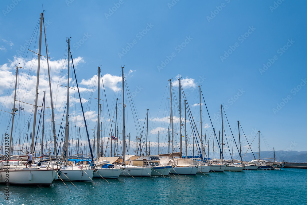 Yachts in the port against the background of clouds.