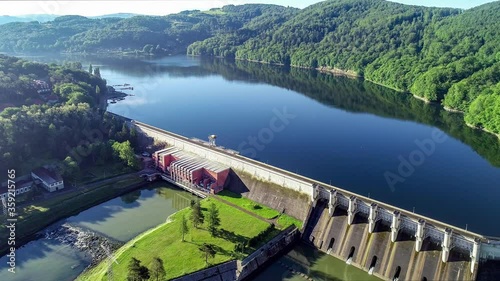 Rożnów dam, lake and hydroelectric power plant on the Dunajec River in Poland. Aerial approaching video. Early morning in spring