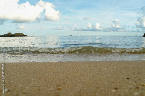 Sea with beach sand and blue sky.