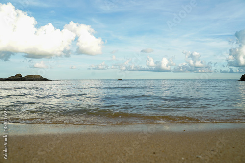 Sea with beach sand and blue sky.