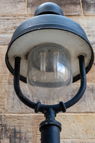 energy saving lightbulb inside traditional old street lamp  photo