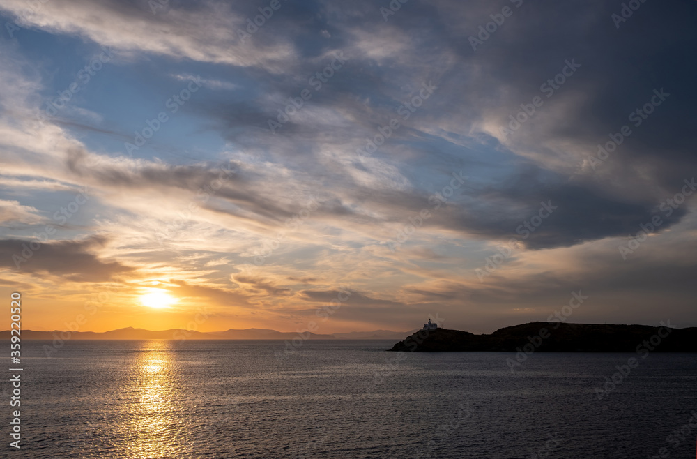 Mediterranean sea. Beautiful sunset and a lighthouse at Kea island, Greece.