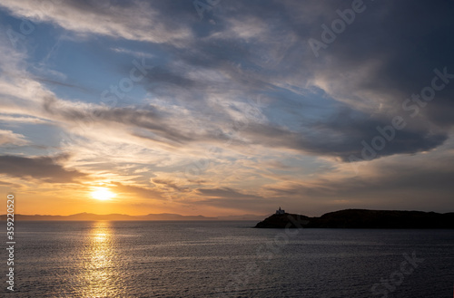 Mediterranean sea. Beautiful sunset and a lighthouse at Kea island  Greece.