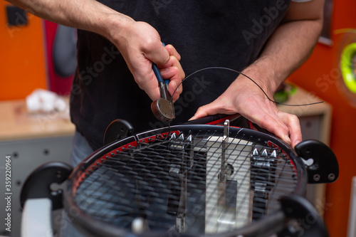 Process of stringing a tennis racket in a tennis shop, sport and leisure concept © Khaligo