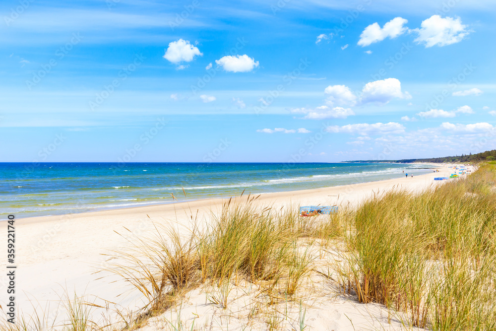 Beautiful white sand beach with dunes and blue sea near Kolobrzeg, Baltic Sea coast, Poland Beautiful white sand beach with dunes and blue sea near Kolobrzeg, Baltic Sea coast, Poland