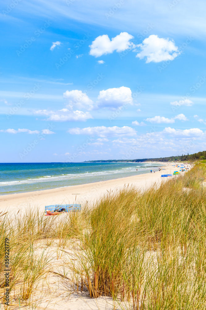 Beautiful white sand beach with dunes and blue sea near Kolobrzeg, Baltic Sea coast, Poland Beautiful white sand beach with dunes and blue sea near Kolobrzeg, Baltic Sea coast, Poland