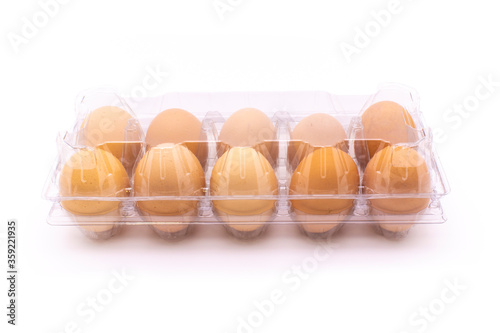 Organic eggs in transparent package, on white background. Freshly packaged organic egg packs