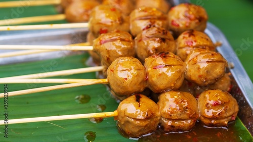 Close up of Grill Meatballs on wooden skewers thai street food market