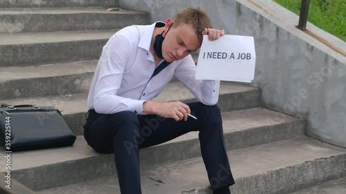 Unemployed sad job seeker with the inscription 