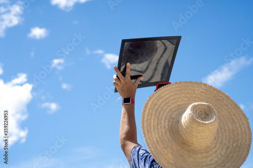 man viewing a solar eclipse via DIY telescope with indirect observation method photo