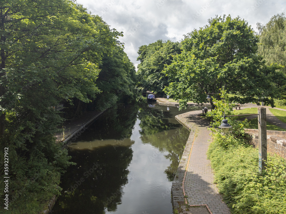 A canal boat moored up near the Vale village on the Birmingham and Worcester Canal, Birmingham, England A canal boat moored up near the Vale village on the Birmingham and Worcester Canal, Birmingham, England