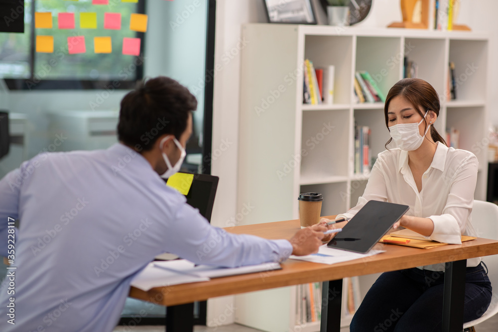 Business man and woman wearing face mask meeting and work together Business man and woman wearing face mask meeting and work together
