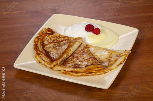 Pancakes with sour cream and condenced milk photo