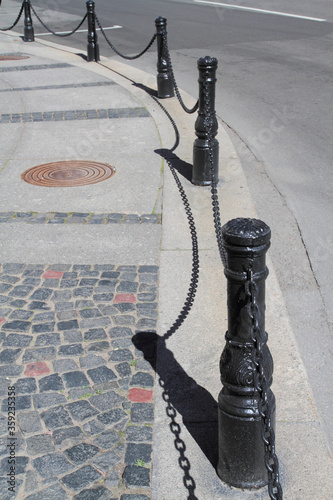 Row Of Metal Safety Pillars Separate The Sidewalk From The Road