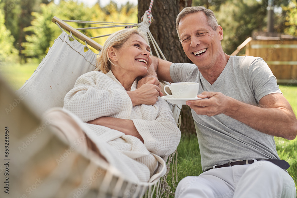 Happy spouses having fun outside house in morning Happy spouses having fun outside house in morning