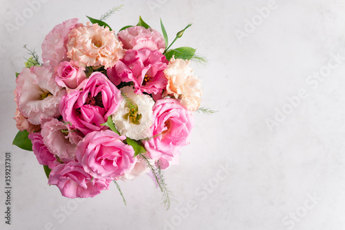 top view of a beautiful bouquet of pastel roses and eustomas on a white background. flower composition. place for text. horizontal image