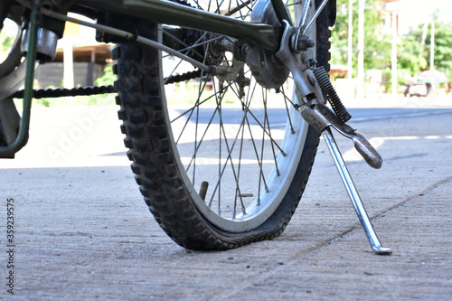 Closeup view of bicycle flat tire on pavement.