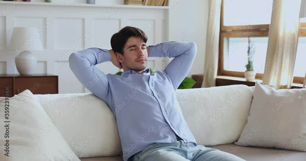 Mindful young handsome man relaxing on cozy couch with folded hands behind head, daydreaming alone in living room. Peaceful millennial man sleeping on comfortable sofa, enjoying stress free weekend. Mindful young handsome man relaxing on cozy couch with folded hands behind head, daydreaming alone in living room. Peaceful millennial man sleeping on comfortable sofa, enjoying stress free weekend.
