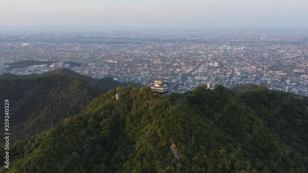 Gifu city and castle aerial pan shot, Japanese sunrise establishing shot Gifu city and castle aerial pan shot, Japanese sunrise establishing shot